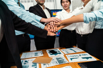 Multiracial business people make synergy hand stack together in meeting room as cooperation or team...