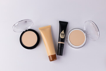 A Collection of Different Makeup Products Including BB Cream, Foundation, and Powder for a Flawless...
