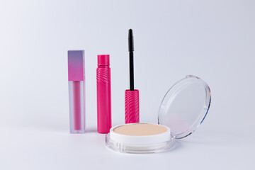A Versatile Collection of Makeup Products Featuring Colorful Lipstick, Vibrant Mascara, and a Smooth Foundation Compact for Flawless Beauty Looks and Everyday Use