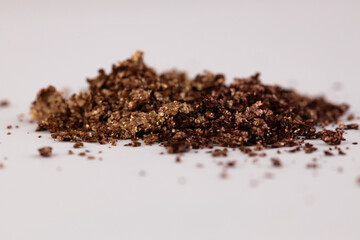 An Intriguing Close-Up of Rich, Textured Crystals or Granules in Varying Shades of Brown and Gold, Capturing Their Unique Forms Against a Soft Background for Visual Impact