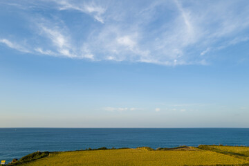 The coast with rice fields and mountains in Asia, Japan, Kansai, Kinosaki, in summer, on a sunny...
