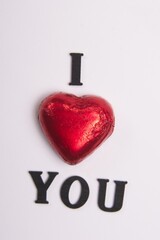 I Love You, using the Red Chocolate heart to represent the word love Black wooden letters on a...