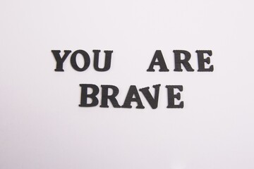 You Are Brave Word Black wooden letters on a white background, 