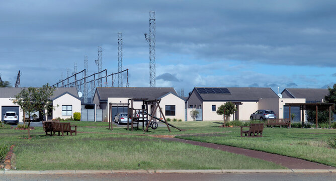 Modern suburban homes lined up in a peaceful neighbourhood. Residential area, real estate development, or new beginnings concept. Architecture and tranquil living.