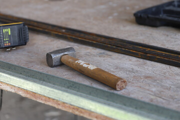 
Hammer and work tools on workshop table
