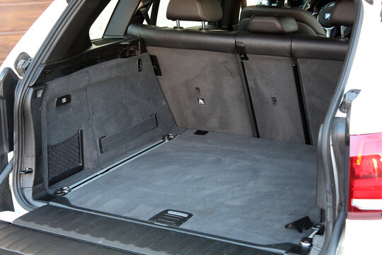Vinnytsia, Ukraine; February 12, 2025. BMW X5 F15 is ready to load luggage. Modern white BMW X5 open trunk. Clean trunk BMW X5 car. Open back door modern SUV. Car open trunk. Car boot is open.
