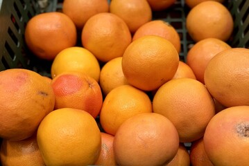 Box with ripe fresh organic tangerines on the shelf of a fruit supermarket are displayed for sale