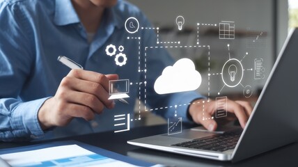 Man works on a cloud computing project using laptop