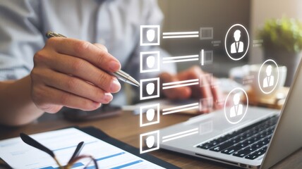 Hand with pen choosing candidates on laptop screen