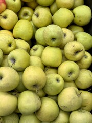 Box filled with fresh juicy natural bio organic green apples placed on counter in local food market