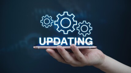 Hand holding phone displaying updating text with glowing gears