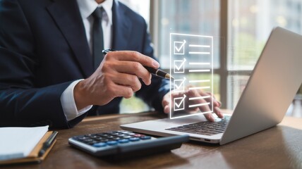 Businessman pointing at a checklist on a laptop screen