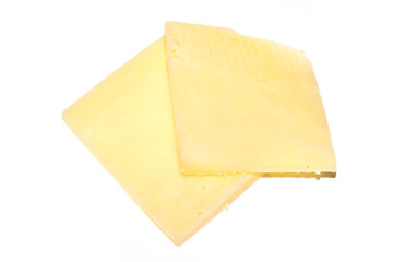 Close up of chedder cheese slices on a white background