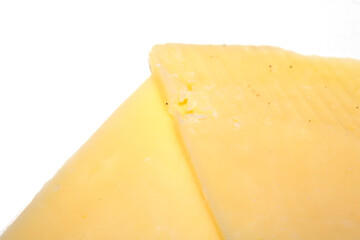 Close up of chedder cheese slices on a white background