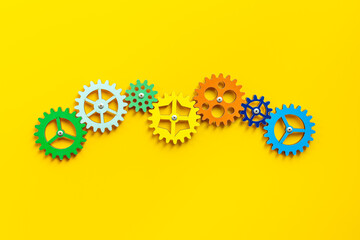Colorful gears are connected together as a symbol of teamwork and business automation