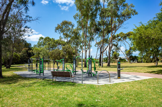 an outdoor fitness area in Cherry Lake Park, Altona, featuring various exercise equipment, a public space designed for health and recreation. Inviting the community to engage in physical activities