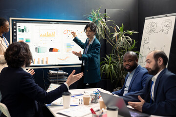 Business coworkers examining performance and efficiency metrics within the enterprise, presenting...