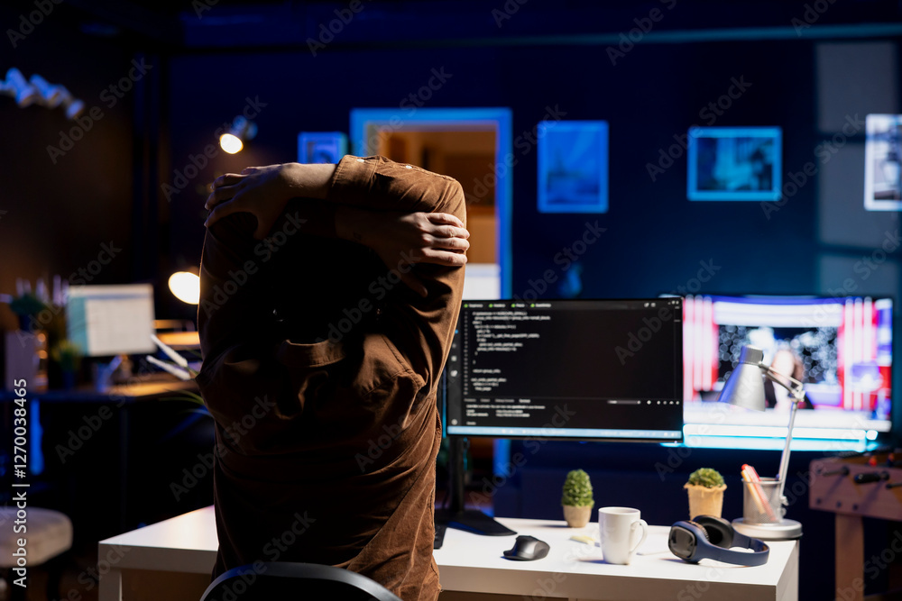 Poster programmer doing software quality assurance, stretching arms behind back after reading source code, 