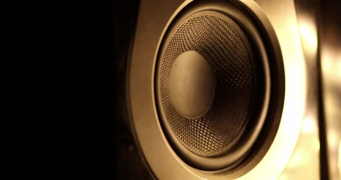 Blasting music on studio speakers. Close up of studio speaker bass subwoofer moving while listening song for music production, and jamming out studio monitors. Sound engineer playing loud music 
