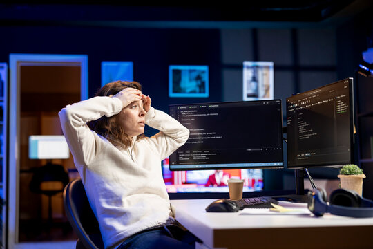 Programmer suffering from headache while filtering malicious traffic from cybercriminals attempting to steal company data. Stressed woman hurting from pain and overworking, preventing malware