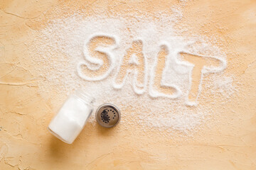 Fine salt in salt shaker and spilled salt. Cooking concept