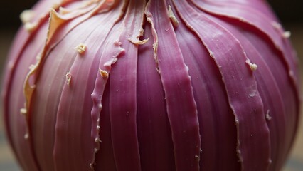 A close-up of a purple onion's wrinkled, papery skin with peeling layers. Lighting highlights its aged and textured surface.