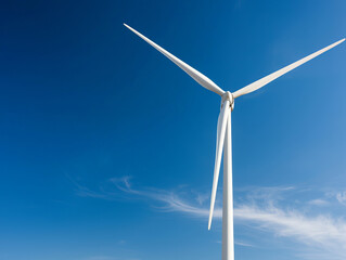 Fototapeta premium Wind turbine against clear blue sky, symbolizing renewable energy and sustainability