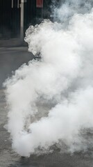 Dense white smoke billowing over asphalt street