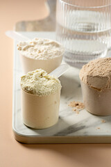 Protein powder in scoops. Different flavours of whey protein powders