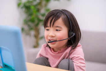 ヘッドセットをつけてオンライン学習をする女の子