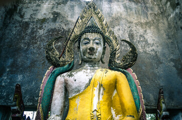 Ancient Buddha statue in a dilapidated structure in Sangklaburi Kanchanaburi Thailand