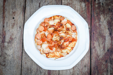 Delicious pizza with toppings on a white plate
