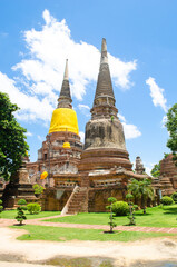 Fototapeta premium Yai Chaimongkol Ayutthaya Thailand, Historic temple with spires and lush greenery