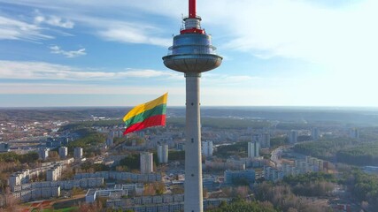 Giant tricolor Lithuanian flag waving on Vilnius television tower on the celebration of restoration of Independence of Lithuania on the 11th of March.