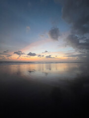 Black Blue, Orange Golden sunsetwith clouds reflection on the beach in Bali, Indonesia - Concept of Nature, Travel, 
