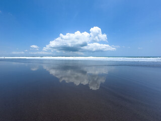 Cloud reflection on beach in Bali Asia - concept of photography, travel, nature, mirror, mirroring