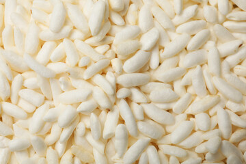 Wholegrain puffed rice as background, closeup view