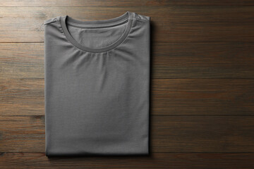Blank grey t-shirt on wooden background, top view. Mockup for design
