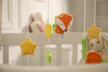 Crib with baby mobile in child's room, closeup