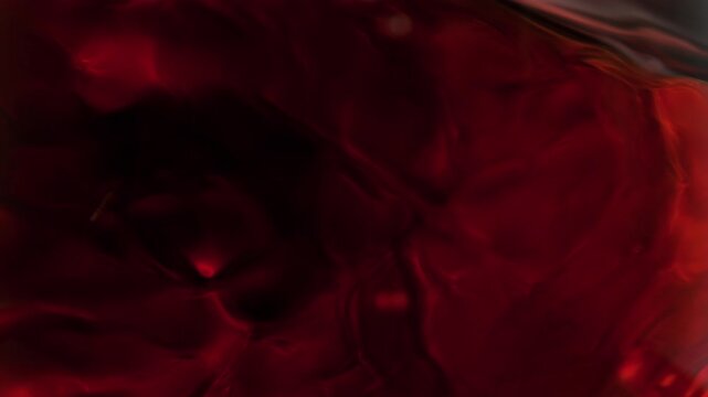 Super Slow Motion Macro Shot of Spinning Red Wine in Glass at 1000fps.