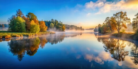 Obraz premium Serene Autumn River at Sunrise Misty Morning Reflection of Colorful Trees and Tranquil Water