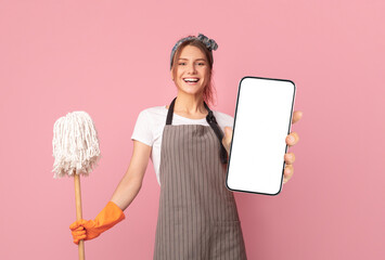 Household Duties. Cheerful Young Woman With Mop And Cleaning Supplies Posing Over Pink Background...