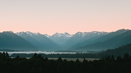 Serene mountain landscape at dawn with misty valley and soft pastel sky in background