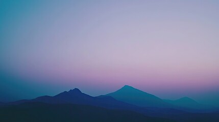 Serene twilight landscape showcasing layered mountains under a gradient sky at dusk