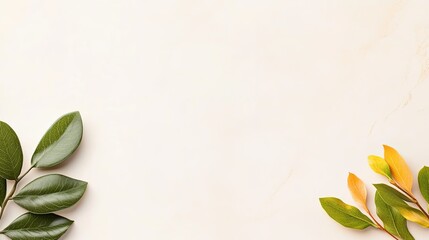 Elegant arrangement of green and yellow leaves on a soft marble background, ideal for nature-themed designs