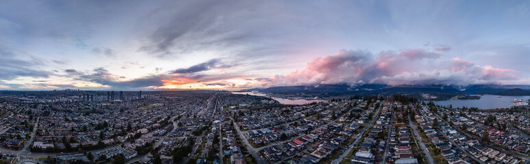 Aerial Cityscape View During a Vibrant Sunset Over Urban and Natural Landscapes