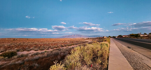 Full view of mountains, blue sky, and clouds in the early evening.