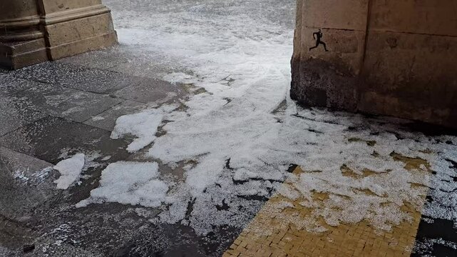 Dangerous wet icy sidewalk with person slipping and almost falling
