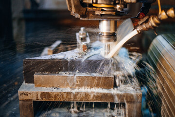 Metalworking machine cutting with cooling liquid showcasing precision manufacturing and industrial...