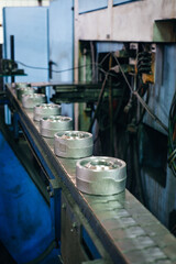 Metal components move along a conveyor belt in an industrial facility showcasing manufacturing...